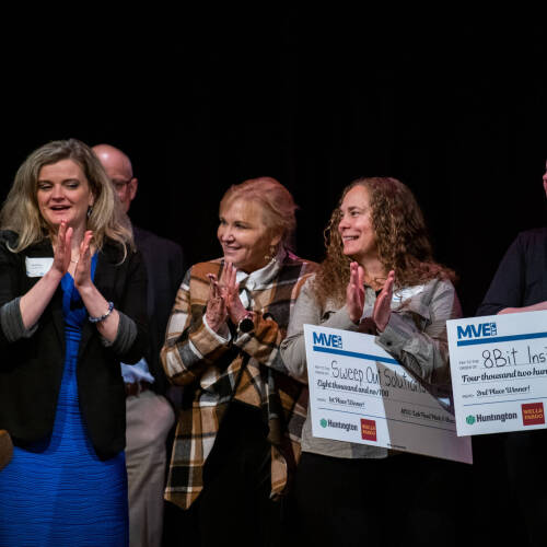 At far left are Shorouq Almallah and Brittany VanderBeek. MVE-Lab participants Hahna Martinez and Sabrina Jordan are at the right, holding checks for winning part of the prize money at the pitch competition May 19 at the Traverse City Opera House.